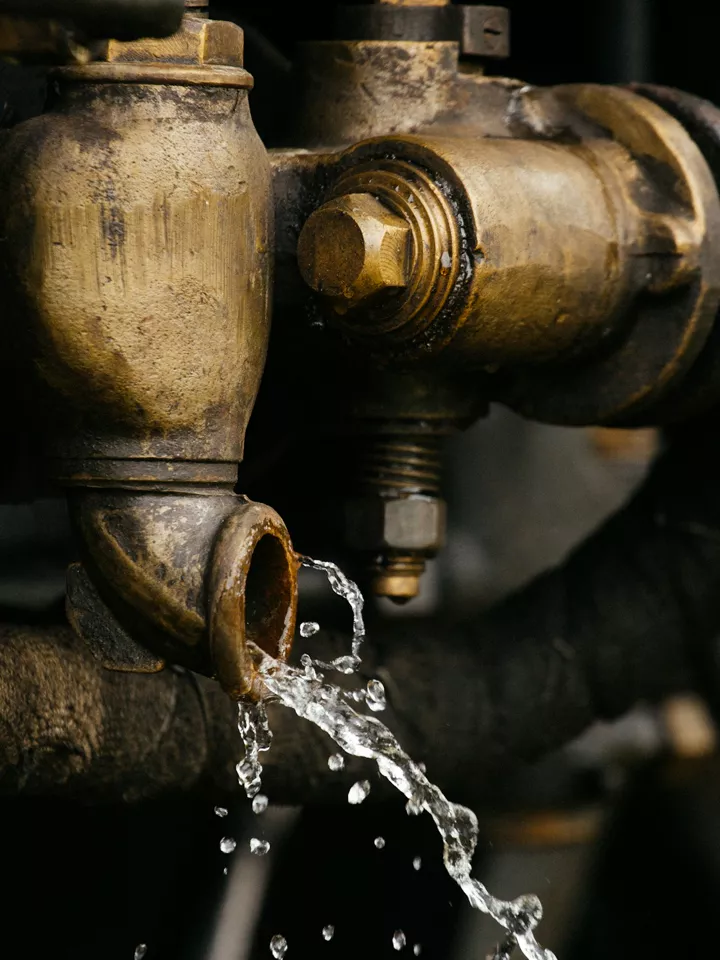 Water running from an old brass pipe fitting